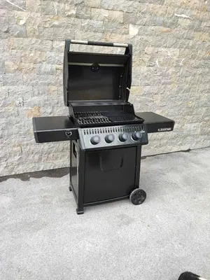 a black barbecue grill sitting next to a brick wall at APARTMAJI SILVA in Slappe dʼIdria