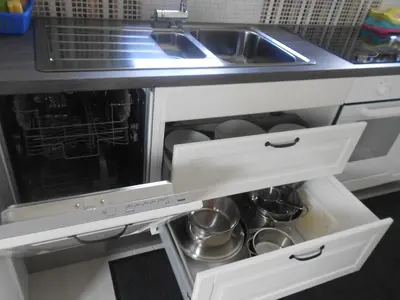 an open kitchen drawer with pots and pans at Apartment Knap in Cerknica