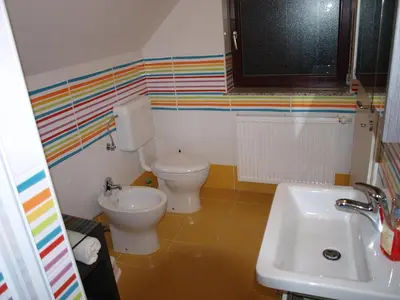 a bathroom with a toilet and a sink at Apartment Knap in Cerknica