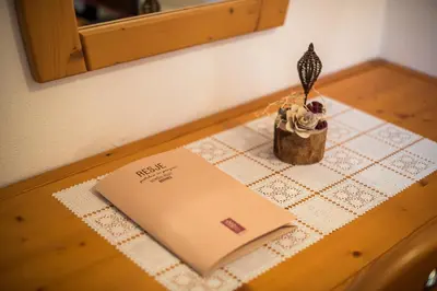 a table with a book and a pen on a table at Bed & Breakfast Hisa Resje in Bohinj