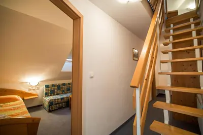a room with a staircase leading to a living room at Bed & Breakfast Hisa Resje in Bohinj