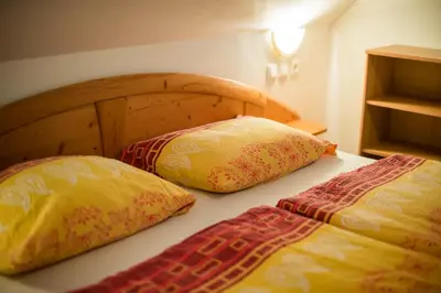 two pillows sitting on a bed in a room at Bed & Breakfast Hisa Resje in Bohinj