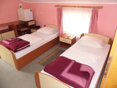 a bedroom with two beds and a window at Guesthouse Pri Štefanu in Most na Soči