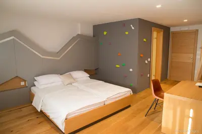 a bedroom with a bed with a climbing wall at Penzion Repnik in Kamnik