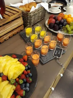 a buffet with fruit and glasses of orange juice and fruit at Penzion Repnik in Kamnik