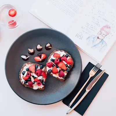 a plate of food with fruit and cookies on it at Apartment Vila Pavlovski in Bled