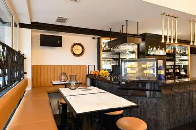 a restaurant with a counter and a bar at Apartment Vila Pavlovski in Bled