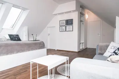 a living room with a couch and a table at Apartment Vila Pavlovski in Bled