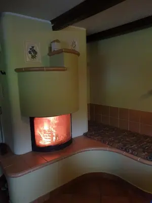 a kitchen with a fireplace in a room at Apartments Relax Jezerca in Cerklje na Gorenjskem