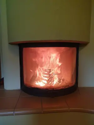 a fire in a fireplace in a room at Apartments Relax Jezerca in Cerklje na Gorenjskem