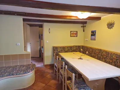 a dining room with a long table and chairs at Apartments Relax Jezerca in Cerklje na Gorenjskem