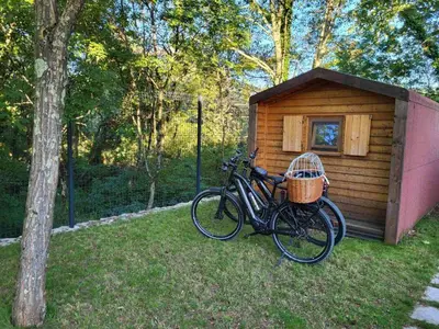 a bike parked in front of a wooden cabin at Krasen Kras 104 resort in Komen