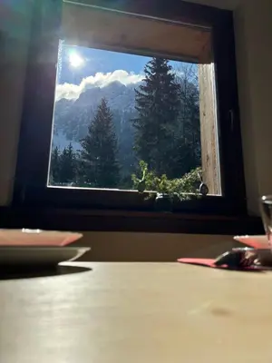 a window with a view of a mountain view at Mountain hut Dom pod Storžičem in Tržič
