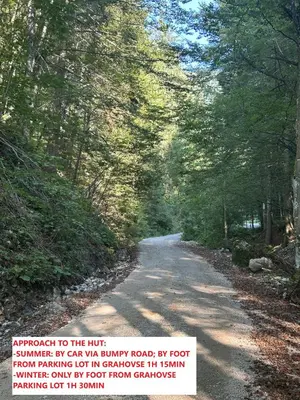 a picture of a road with a sign on it at Mountain hut Dom pod Storžičem in Tržič