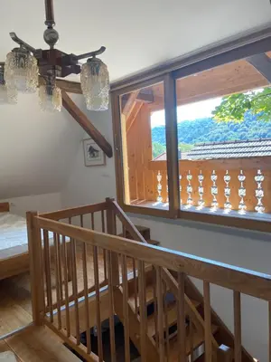 a room with a staircase and a window with a view at Pr Krač Countryside Hideaway in Dol pri Ljubljani