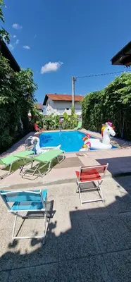 a group of lawn chairs and a swimming pool at APARTMAN MURKO P-4 in Ljubljana