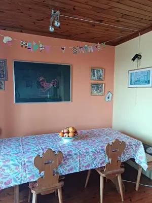 a dining room table with two chairs and a bowl of fruit at Kralj Matjaž - the green escape under Alps in Golnik