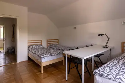 a room with two beds and a table with a lamp at Apartment Bogomila in Ljubljana