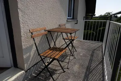 a wooden table and two chairs on a balcony at Apartment Bogomila in Ljubljana