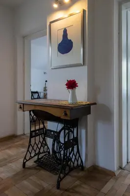 a table in a room with a vase of flowers on it at Apartment Bogomila in Ljubljana
