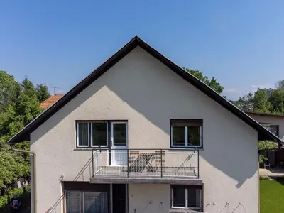 a house with a balcony on the side of it at Apartment Bogomila in Ljubljana