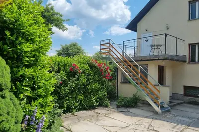 a staircase on the side of a house with flowers at Apartment Bogomila in Ljubljana