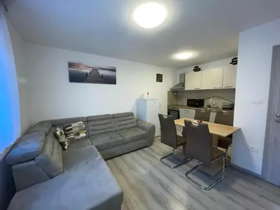 a living room with a couch and a table at APARTMA DŽANA in Žaga