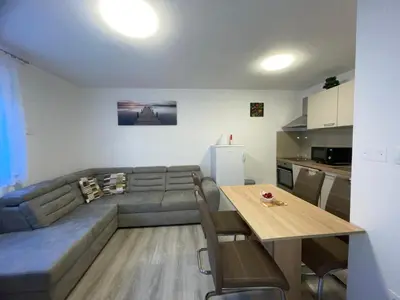 a living room with a couch and a table at APARTMA DŽANA in Žaga
