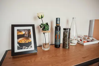 a table with a picture and a vase with a flower at Kocbek since 1929 in Sveti Jurij ob Ščavnici