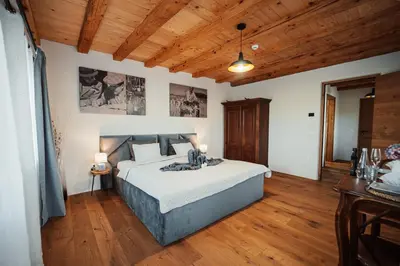 a bedroom with a bed and a wooden ceiling at Kocbek since 1929 in Sveti Jurij ob Ščavnici