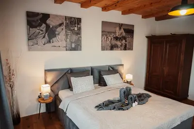 a bedroom with a bed with a blanket on it at Kocbek since 1929 in Sveti Jurij ob Ščavnici