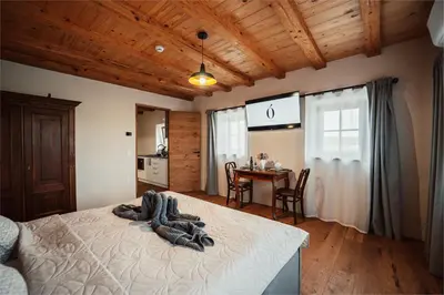 a bedroom with a bed and a table with chairs at Kocbek since 1929 in Sveti Jurij ob Ščavnici