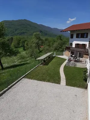 a view of a house with a fence at Holiday House Dori in Kobarid