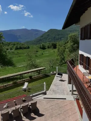 a balcony of a house with a view of the mountains at Holiday House Dori in Kobarid