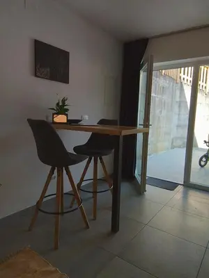 a table and two chairs in a living room at Hiša za Gradom in Kobarid