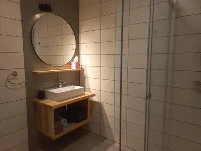 a bathroom with a sink and a mirror at Hiša za Gradom in Kobarid