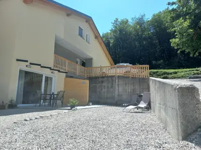 a house with a fence and a patio at Hiša za Gradom in Kobarid