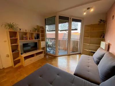 a living room with a couch and a television at Apartma Felicija in Ljubljana