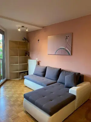 a living room with a blue couch in a room at Apartma Felicija in Ljubljana