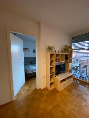 a room with a bedroom with a bed and a book shelf at Apartma Felicija in Ljubljana