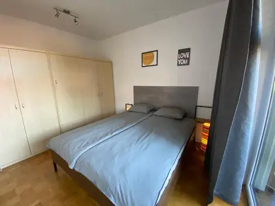 a bedroom with a large bed with blue sheets at Apartma Felicija in Ljubljana