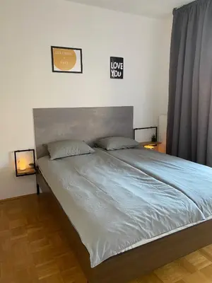 a bedroom with a large bed with blue sheets at Apartma Felicija in Ljubljana