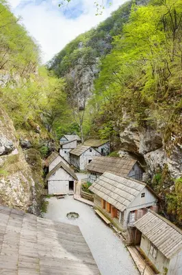 a group of houses on a mountain with a road at Bomas house in Cerkno