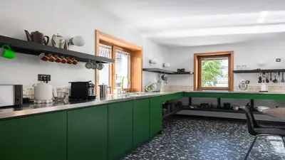 a kitchen with green cabinets and a counter top at Vila Vrba in Žirovnica