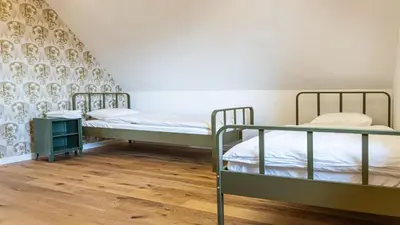 two bunk beds in a room with wooden floors at Vila Vrba in Žirovnica