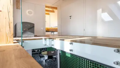 a kitchen with white cabinets and green tile on the counter at Vila Vrba in Žirovnica