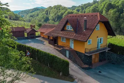 a yellow house with a red roof at Holiday Home Lanita with Two Bedrooms & Terrace in Podbočje