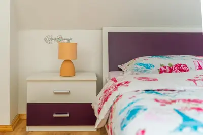 a bedroom with a bed and a lamp on a nightstand at Holiday Home Lanita with Two Bedrooms & Terrace in Podbočje