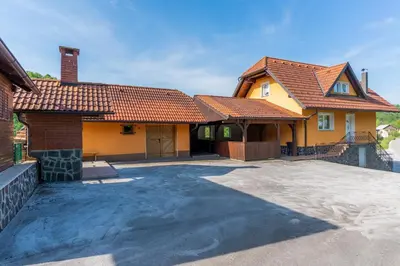 a house with a driveway in front of it at Holiday Home Lanita with Two Bedrooms & Terrace in Podbočje