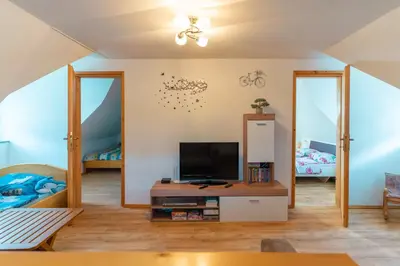 a living room with a tv and two beds at Holiday Home Lanita with Two Bedrooms & Terrace in Podbočje